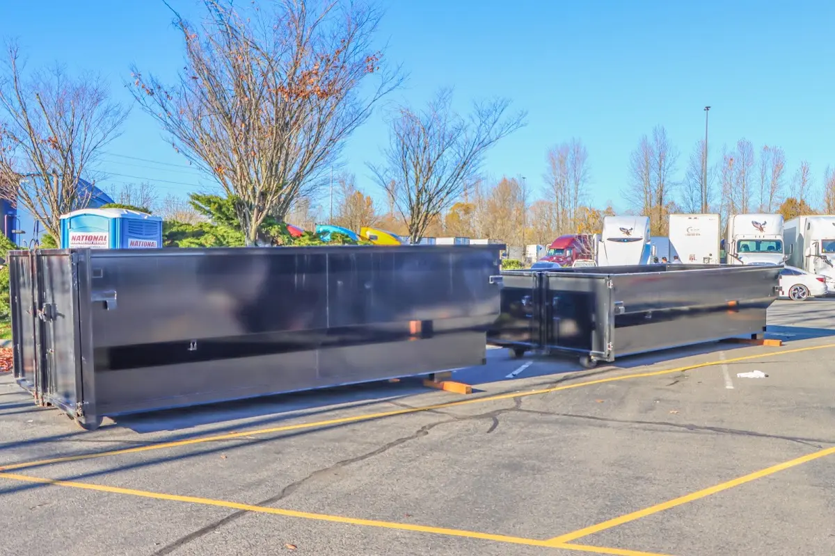 Professional dumpster rental service with roll-off container on residential driveway in Lake Worth Beach